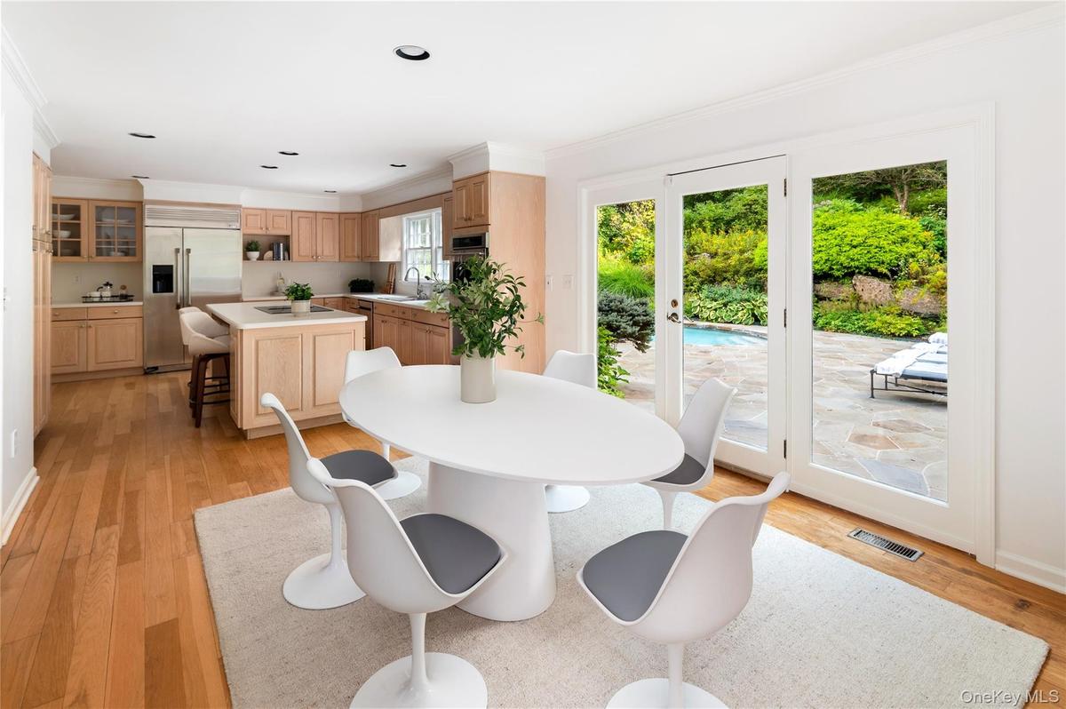 Showing large eat-in area with doors to rear property and pool