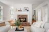 Formal living room with double sided fireplace, formal dinning room beyond