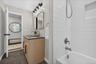 Dual vanity with wood-finish cabinetry and rectangular vessel sinks