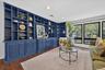 Built-in shelving with lower cabinetry, wood-finish flooring, recessed lighting, and large windows with dark frames