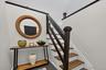Hardwood tread staircase with dark stained newel post and railings