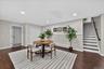 Lower-level-Recessed lighting illuminates wood-finish flooring and light gray walls