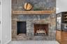 Stone fireplace with a substantial wood mantel