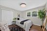 Hardwood flooring, light gray wall paint, white trim, recessed lighting, and white bi-fold closet doors