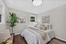 Hardwood flooring, light-toned wall finishes, recessed ceiling light fixture, window with exterior light, white trim molding