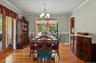 Dining room with oak floors and view into four seasons room