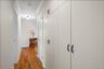 Hallway with floor to ceiling closets.