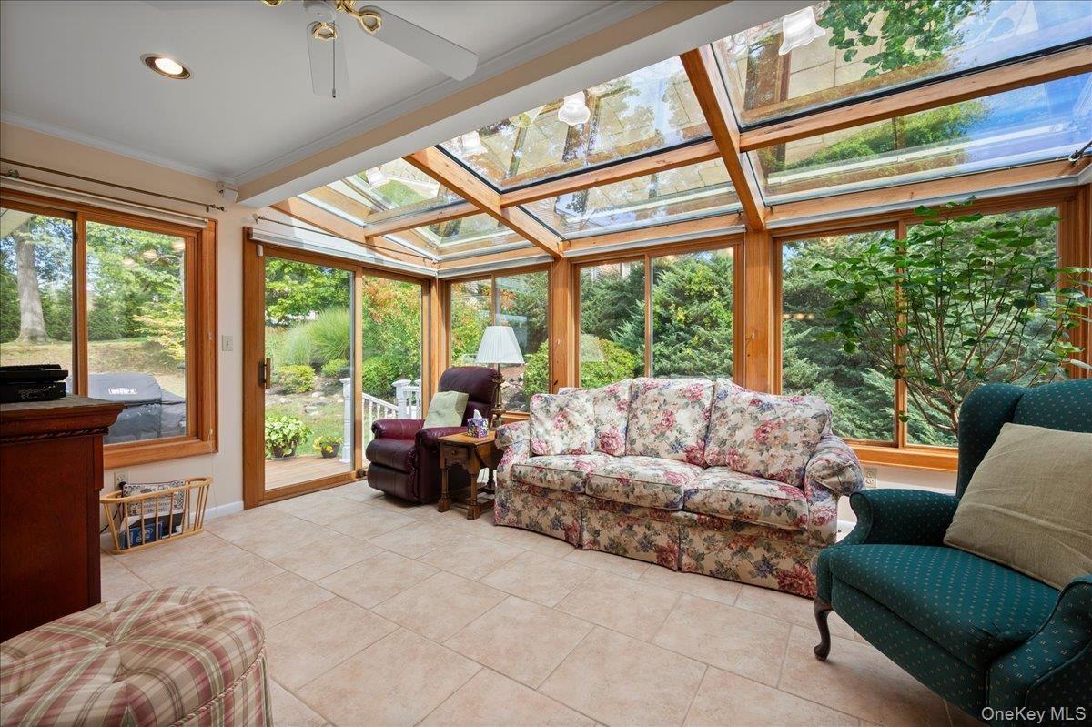 Four seasons room with slider to deck and windows that when open create a screened in porch feel