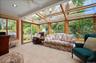 Four seasons room with slider to deck and windows that when open create a screened in porch feel
