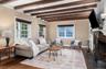 Front living room with original beams and woodburning fireplace