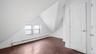Bonus room with dark hardwood / wood-style flooring, a baseboard radiator, and lofted ceiling