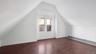 Bonus room featuring a baseboard heating unit, dark wood-type flooring, and vaulted ceiling