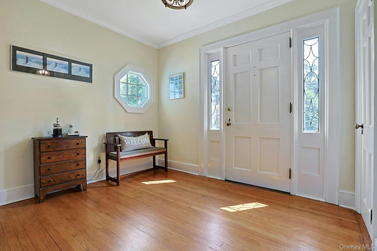 Welcoming foyer. Coat closet, charming window and sidelights.