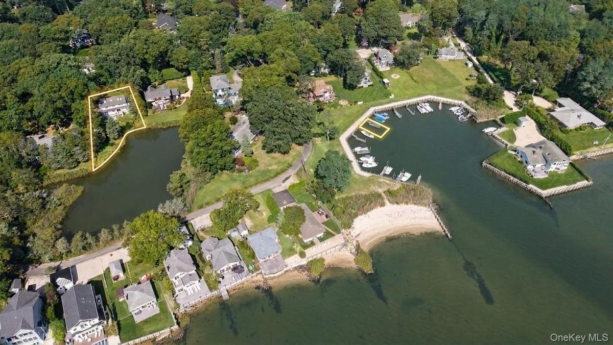 Aerial view of the waterfront property, boat slip, private beach, marina