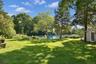 Large yard with gardens and a shed
