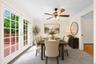 Virtually staged  dining room with french doors out to deck