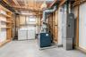 Laundry area with concrete flooring, exposed ceiling joists, and a utility sink