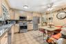 Kitchen featuring light-toned cabinetry, tile flooring, and stainless steel appliances