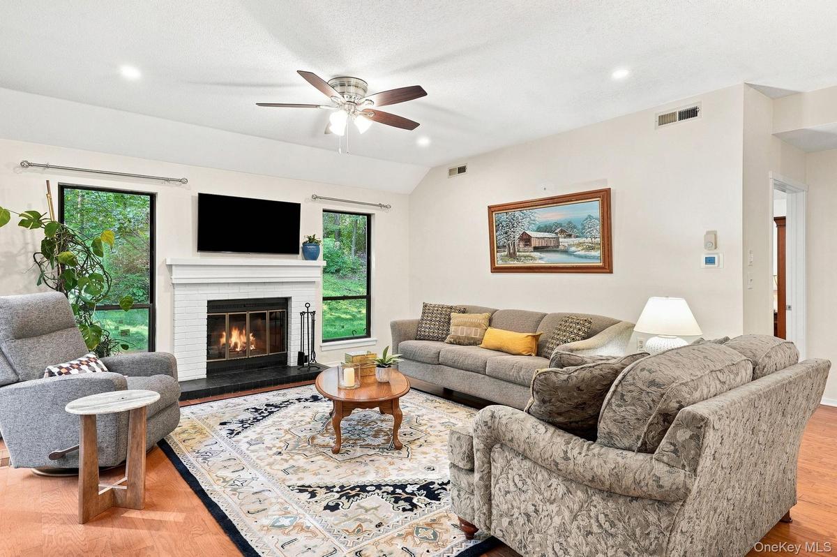 Open ConceptLivingroom w/ Fireplace access to patio
