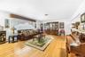 Light wood-finish flooring, white walls, and a multi-level floor plan with visible stairs