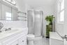 White vanity with integrated sink and chrome faucet