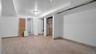 Unfurnished bedroom featuring a baseboard radiator, connected bathroom, and light wood-type flooring