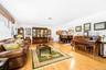 Light wood-finish flooring, white walls, and a multi-level floor plan with visible stairs