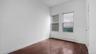 Empty room with a baseboard radiator and dark hardwood / wood-style floors
