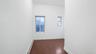 Empty room with a baseboard heating unit and dark hardwood / wood-style flooring