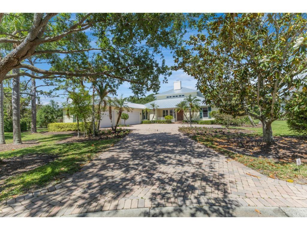 The expansive brick paver driveway offers ample parking
