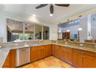 The spacious kitchen is open to bar top seating and offers a view of the pool and lanai area.