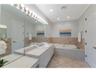 This side of the primary en-suite bath has a large jetted tub, perfect for relaxing after a round of golf