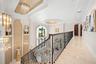 Upper Level Gallery Walkway with Grand Overlook of living area and chandeliers