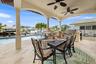 Covered Outdoor Dining with Pool and Water View