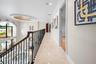 Upper Level Gallery Walkway with Grand Overlook of living area and chandeliers