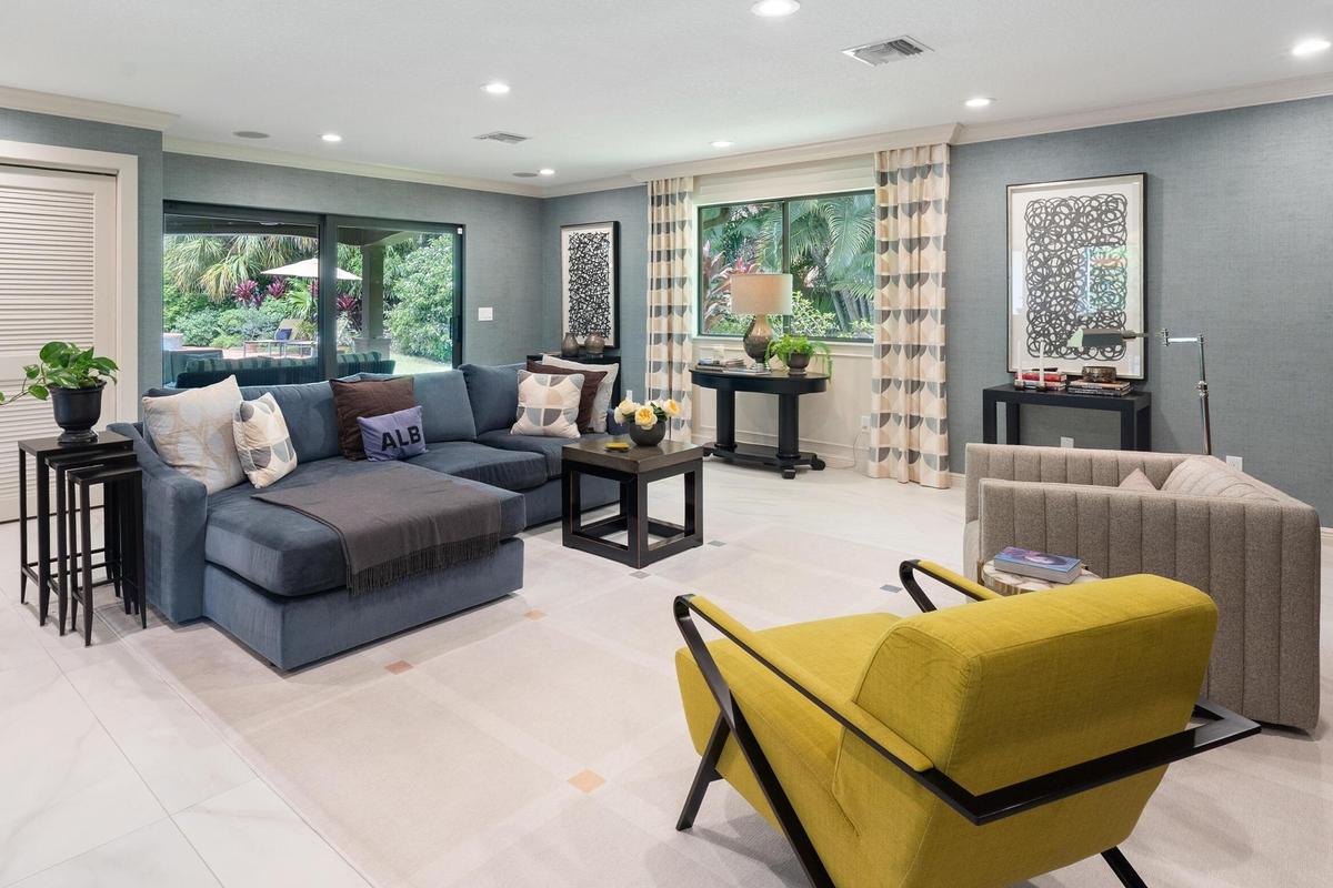 Recessed lighting, large format tile flooring, sliding glass doors, and a window with custom drapery