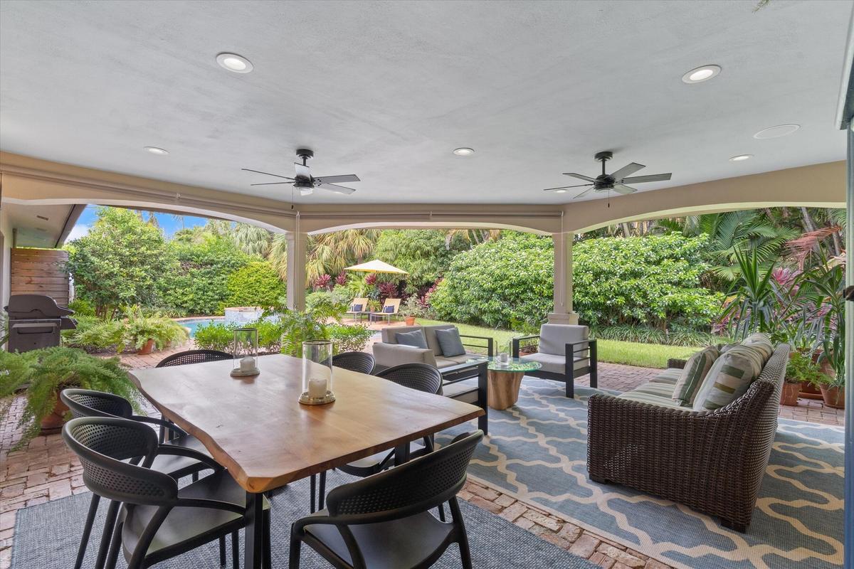 Expansive covered patio with recessed lighting and ceiling fans
