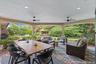 Expansive covered patio with recessed lighting and ceiling fans