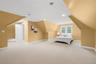 The third-level recreation room is currently being used as a bedroom.
