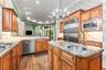 Updated kitchen with Fusion polished granite countertops and designer backsplash