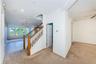Stairway to bedroom level and a powder room outside the living room