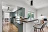 Contemporary kitchen with stainless steel appliances and breakfast bar