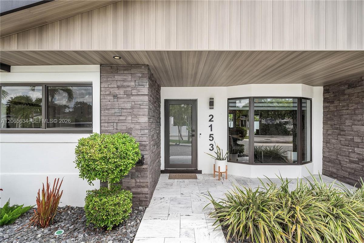 Stone work/ treated wood panels/ bay window
