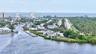 Coastal community with waterway access, lush landscaping, and distant ocean presence