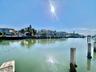Waterfront property with concrete pilings and a canal