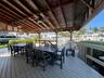 Covered outdoor deck with exposed wood beam ceiling, two ceiling fans, and composite decking