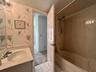Bathroom featuring a built-in vanity with an integrated sink and a cultured marble countertop, a shower/tub combination with a wall-mounted shower hea