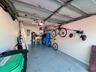 Attached garage with an overhead door, smooth interior walls, and an epoxy-coated concrete floor