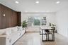 Bright and spacious open-concept living and dining area featuring recessed lighting, modern finishes, and abundant natural light from oversized window
