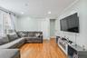 Spacious living room featuring hardwood floors, recessed lighting, and a comfortable open layout. 1st Floor.